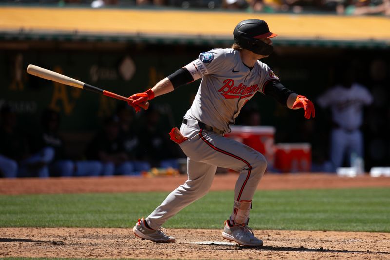Jul 7, 2024; Oakland, California, USA; Baltimore Orioles shortstop Gunnar Henderson (2) follows through on his RBI single against the Oakland Athletics during the ninth inning at Oakland-Alameda County Coliseum. Mandatory Credit: D. Ross Cameron-USA TODAY Sports