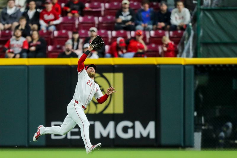 Apr 9, 2024; Cincinnati, Ohio, USA; Cincinnati Reds outfielder Jake Fraley (27) catches a pop up hit by Milwaukee Brewers designated hitter Rhys Hoskins (not pictured) in the sixth inning at Great American Ball Park. Mandatory Credit: Katie Stratman-USA TODAY Sports