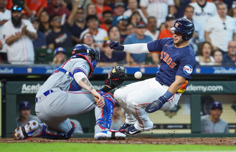 Apr 14, 2024; Houston, Texas, USA; Houston Astros designated hitter Yainer Diaz (21) is tagged out by Texas Rangers catcher Jonah Heim (28) on a play at the plate during the fifth inning at Minute Maid Park. Mandatory Credit: Troy Taormina-USA TODAY Sports