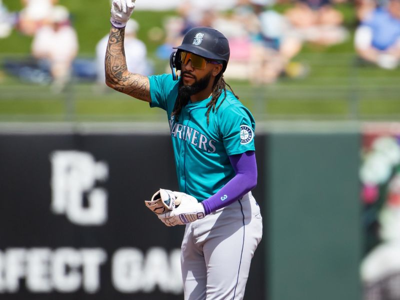 Mar 18, 2024; Surprise, Arizona, USA; Seattle Mariners infielder J.P. Crawford celebrates after hitting a double against the Texas Rangers during a spring training baseball game at Surprise Stadium. Mandatory Credit: Mark J. Rebilas-USA TODAY Sports