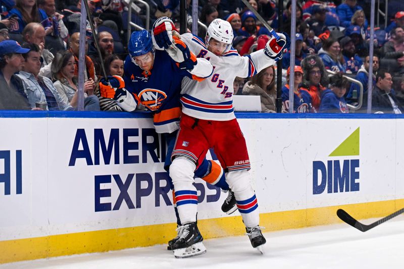 Apr 10, 2025; Elmont, New York, USA;  New York Rangers defenseman Braden Schneider (4) checks New York Islanders right wing Maxim Tsyplakov (7) into the boards during the second period at UBS Arena. Mandatory Credit: Dennis Schneidler-Imagn Images