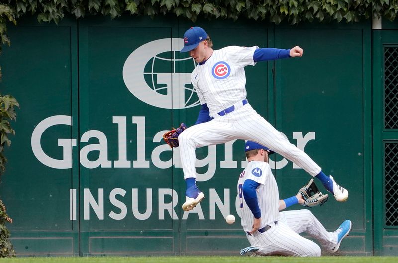 Sep 27, 2024; Chicago, Illinois, USA; Chicago Cubs outfielder Pete Crow-Armstrong (front) and outfielder Kevin Alcantra (back) cannot catch a double hit by Cincinnati Reds shortstop Elly De La Cruz (not pictured) during the first inning at Wrigley Field. Mandatory Credit: David Banks-Imagn Images