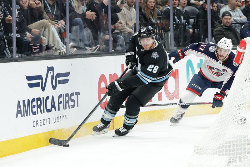 Jan 31, 2025; Salt Lake City, Utah, USA;  Utah Hockey Club defenseman Ian Cole (28) tries to get away from Columbus Blue Jackets right wing Justin Danforth (17) during the first period at Delta Center. Mandatory Credit: Chris Nicoll-Imagn Images