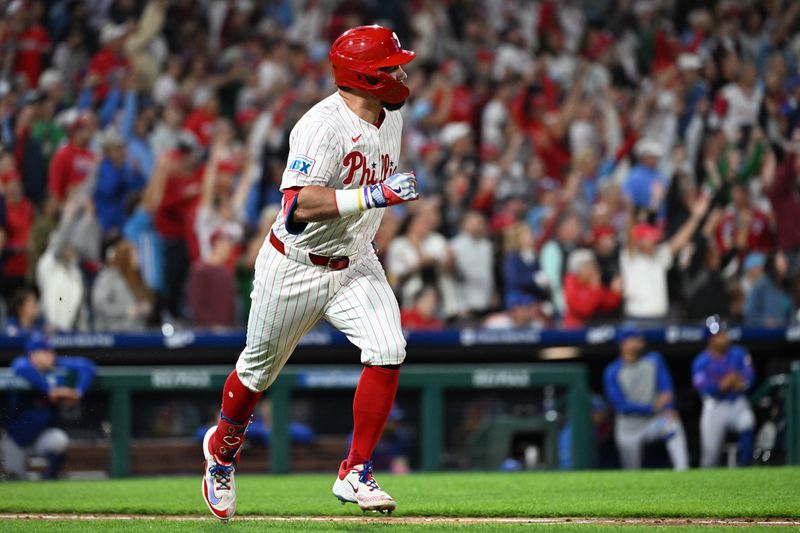 Sep 9, 2025; Philadelphia, Pennsylvania, USA; Philadelphia Phillies outfielder Kyle Schwarber (12) watches his 50th home run of the year during the seventh inning against the New York Mets at Citizens Bank Park. Mandatory Credit: Eric Hartline-Imagn Images
