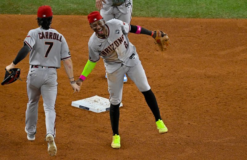 Oct 28, 2023; Arlington, Texas, USA; Arizona Diamondbacks shortstop Geraldo Perdomo (2) and right fielder Corbin Carroll (7) celebrates the Diamondbacks victory over the Texas Rangers in game two of the 2023 World Series at Globe Life Field. Mandatory Credit: Jerome Miron-USA TODAY Sports