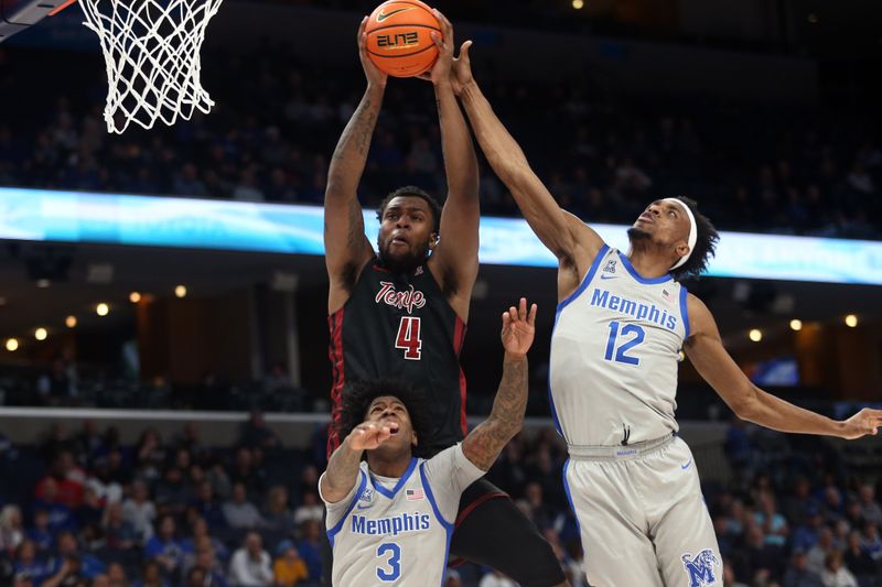 Feb 12, 2023; Memphis, Tennessee, USA; Temple Owls forward Jamille Reynolds (4) collects a rebound over Memphis Tigers guard Kendric Davis (3) and forward DeAndre Williams (12) during the second half at FedExForum. Mandatory Credit: Petre Thomas-USA TODAY Sports