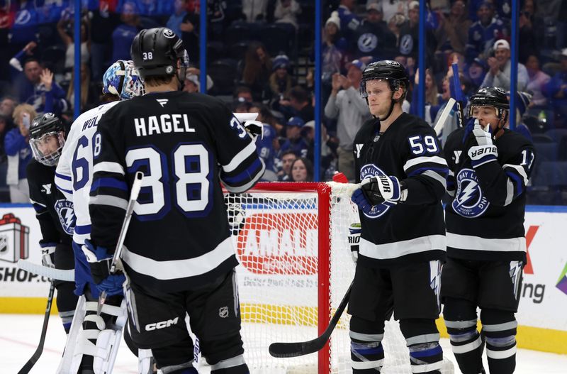 Nov 30, 2024; Tampa, Florida, USA; Tampa Bay Lightning center Jake Guentzel (59) is congratulated after he scored a goal against the Toronto Maple Leafs during the third period at Amalie Arena. Mandatory Credit: Kim Klement Neitzel-Imagn Images