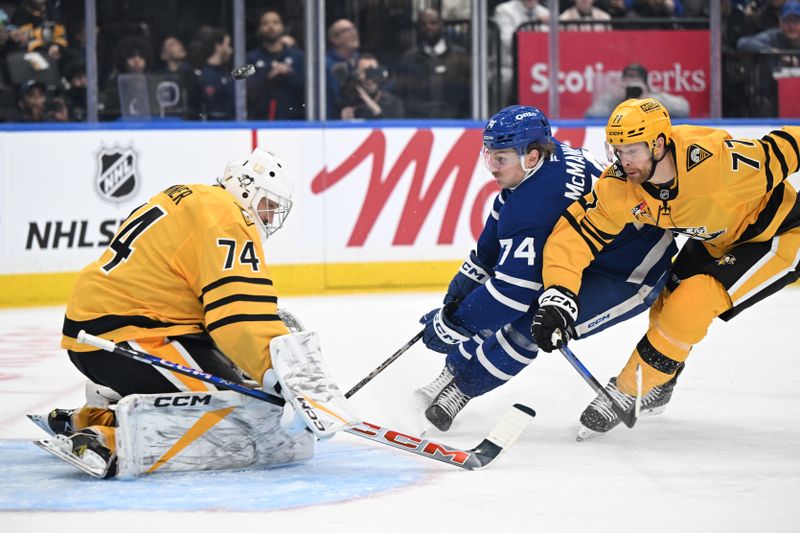 Dec 23, 2025; Toronto, Ontario, CAN;  Pittsburgh Penguins goalie Stuart Skinner (74) stops a scoring attempt from Toronto Maple Leafs forward Bobby McMann (74) as defenseman Brett Kulak (77) trails the play in the first period at Scotiabank Arena. Mandatory Credit: Dan Hamilton-Imagn Images