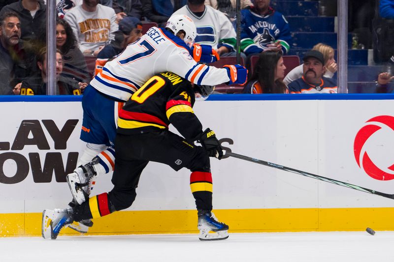 Nov 6, 2023; Vancouver, British Columbia, CAN; Edmonton Oilers forward Warren Foegele (37) hits Vancouver Canucks forward Elias Pettersson (40) in the third period at Rogers Arena. Vancouver won 6-2. Mandatory Credit: Bob Frid-USA TODAY Sports