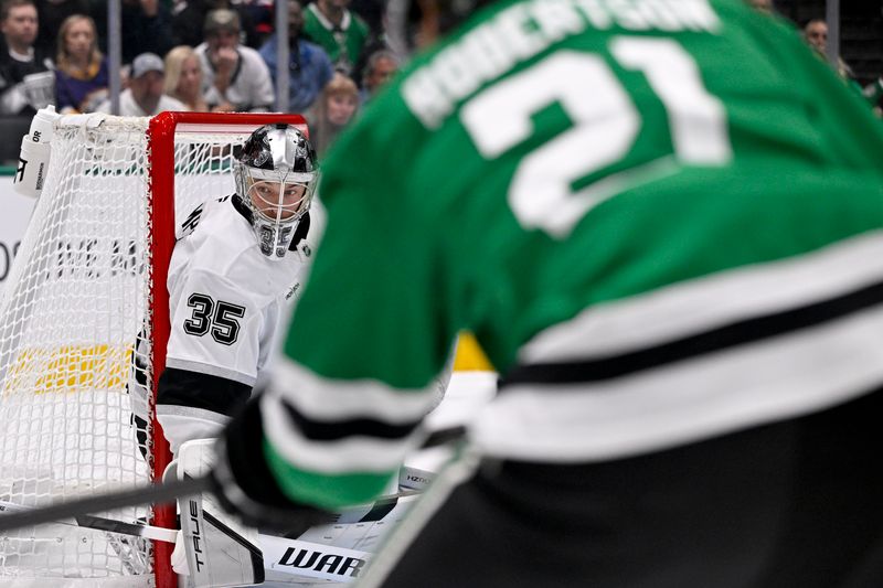 Oct 23, 2025; Dallas, Texas, USA; Los Angeles Kings goaltender Darcy Kuemper (35) faces a shot by Dallas Stars left wing Jason Robertson (21) during the second period at the American Airlines Center. Mandatory Credit: Jerome Miron-Imagn Images