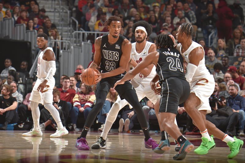 CLEVELAND, OH - NOVEMBER 9: Nicolas Claxton #33 of the Brooklyn Nets looks to pass the ball during the game against the Cleveland Cavaliers on November 9, 2024 at Rocket Mortgage FieldHouse in Cleveland, Ohio. NOTE TO USER: User expressly acknowledges and agrees that, by downloading and/or using this Photograph, user is consenting to the terms and conditions of the Getty Images License Agreement. Mandatory Copyright Notice: Copyright 2024 NBAE (Photo by David Liam Kyle/NBAE via Getty Images)