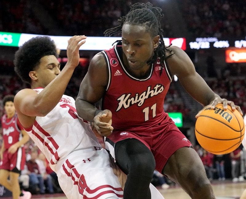 Feb. 18, 2023; Madison, WI, USA; Wisconsin Badgers guard Chucky Hepburn (23) fouls Rutgers Scarlet Knights center Clifford Omoruyi (11) during the first half at the Kohl Center. Mandatory Credit: Mark Hoffman-USA TODAY Sports