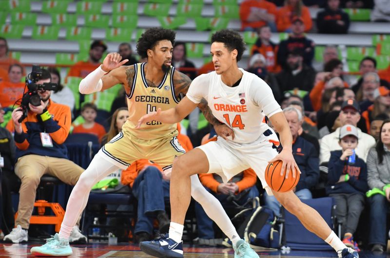 Feb 28, 2023; Syracuse, New York, USA; Syracuse Orange center Jesse Edwards (14) works the ball against the defense of Georgia Tech Yellow Jackets forward Javon Franklin (4) in the first half at the JMA Wireless Dome. Mandatory Credit: Mark Konezny-USA TODAY Sports