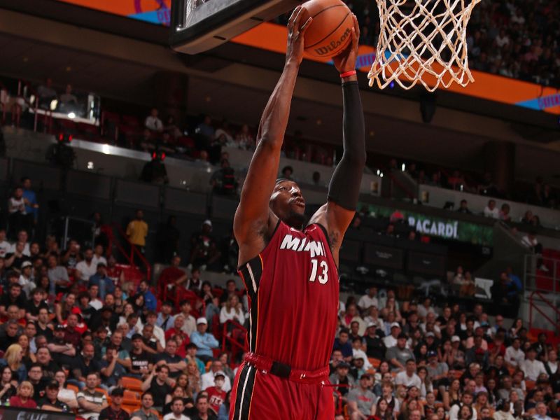 MIAMI, FL - MARCH 10: Bam Adebayo #13 of the Miami Heat rebounds during the game against the Washington Wizards on March 10, 2024 at Kaseya Center in Miami, Florida. NOTE TO USER: User expressly acknowledges and agrees that, by downloading and or using this Photograph, user is consenting to the terms and conditions of the Getty Images License Agreement. Mandatory Copyright Notice: Copyright 2024 NBAE (Photo by Issac Baldizon/NBAE via Getty Images)