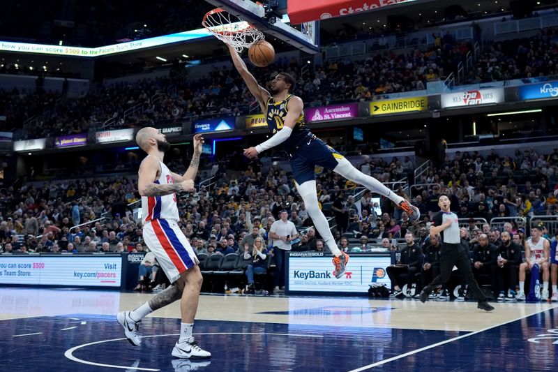 INDIANAPOLIS, INDIANA - FEBRUARY 22: Tyrese Haliburton #0 of the Indiana Pacers dunks the ball past Evan Fournier #31 of the Detroit Pistons in the second quarter at Gainbridge Fieldhouse on February 22, 2024 in Indianapolis, Indiana. NOTE TO USER: User expressly acknowledges and agrees that, by downloading and or using this photograph, User is consenting to the terms and conditions of the Getty Images License Agreement. (Photo by Dylan Buell/Getty Images)