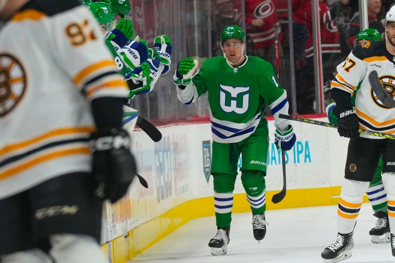 Mar 26, 2023; Raleigh, North Carolina, USA;  Carolina Hurricanes center Jack Drury (18) scores a goal against the Boston Bruins during the second period at PNC Arena. Mandatory Credit: James Guillory-USA TODAY Sports