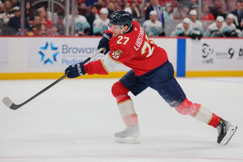 Mar 24, 2026; Sunrise, Florida, USA; Florida Panthers center Eetu Luostarinen (27) shoots the puck against the Seattle Kraken during the first period at Amerant Bank Arena. Mandatory Credit: Sam Navarro-Imagn Images