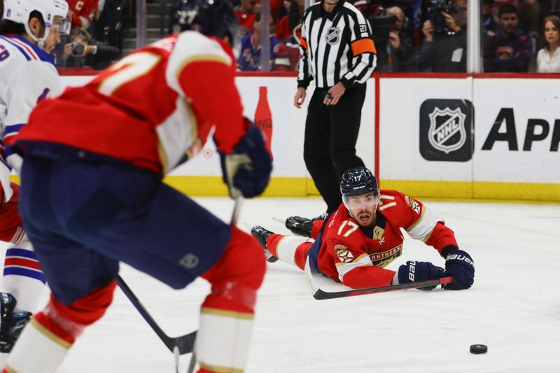 May 26, 2024; Sunrise, Florida, USA;Florida Panthers center Evan Rodrigues (17) passes the puck to center Eetu Luostarinen (27) against the New York Rangers during the first period in game three of the Eastern Conference Final of the 2024 Stanley Cup Playoffs at Amerant Bank Arena. Mandatory Credit: Sam Navarro-USA TODAY Sports