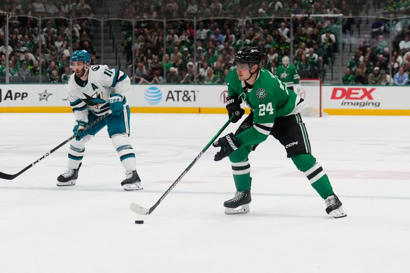 Mar 2, 2024; Dallas, Texas, USA;  Dallas Stars center Roope Hintz (24) skates with the puck ahead of San Jose Sharks center Luke Kunin (11) during the second period at American Airlines Center. Mandatory Credit: Chris Jones-USA TODAY Sports