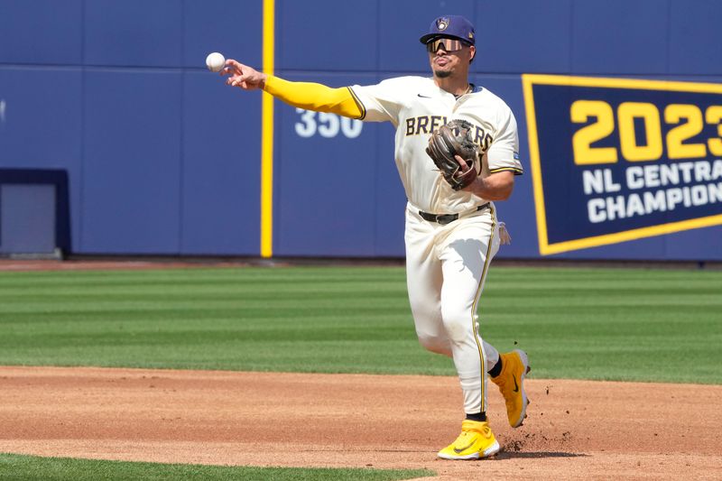 Mar 16, 2024; Phoenix, Arizona, USA; Milwaukee Brewers shortstop Willy Adames (27) makes the play for an out against the Texas Rangers in the first inning at American Family Fields of Phoenix. Mandatory Credit: Rick Scuteri-USA TODAY Sports