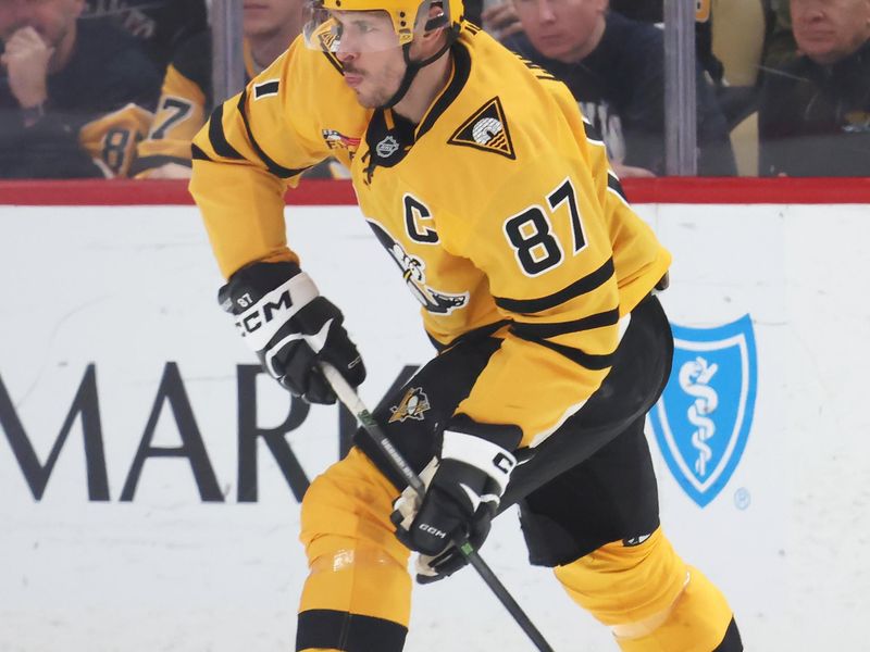 Jan 8, 2026; Pittsburgh, Pennsylvania, USA;  Pittsburgh Penguins center Sidney Crosby (87) handles the puck against the New Jersey Devils during the second period at PPG Paints Arena. Mandatory Credit: Charles LeClaire-Imagn Images