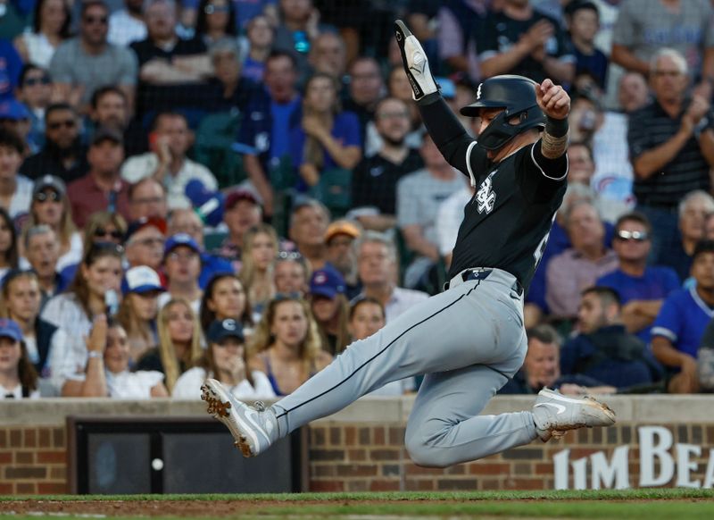 Jun 5, 2024; Chicago, Illinois, USA; Chicago White Sox catcher Korey Lee (26) slides to score against the Chicago Cubs during the fourth inning at Wrigley Field. Mandatory Credit: Kamil Krzaczynski-USA TODAY Sports