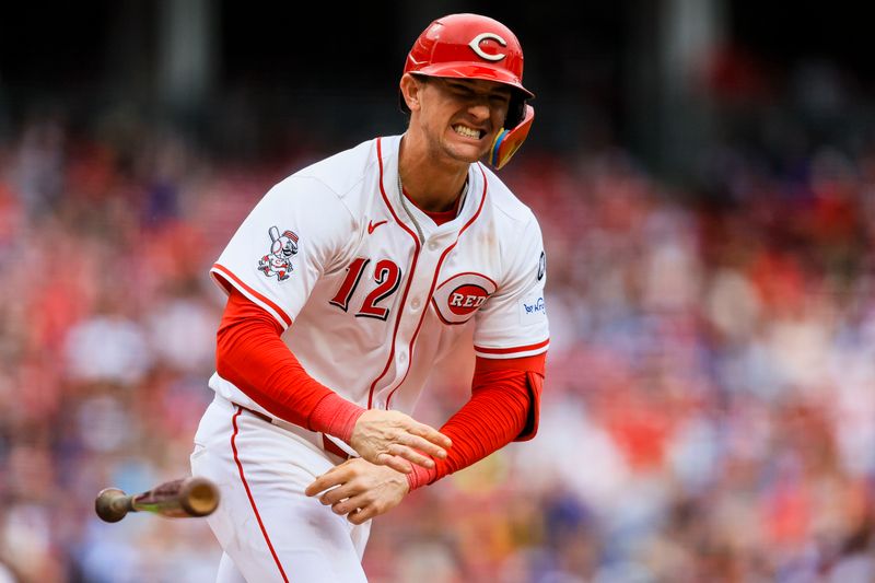 May 25, 2025; Cincinnati, Ohio, USA; Cincinnati Reds outfielder Austin Hays (12) reacts after getting hit by a wild pitch in the seventh inning against the Chicago Cubs at Great American Ball Park. Mandatory Credit: Katie Stratman-Imagn Images