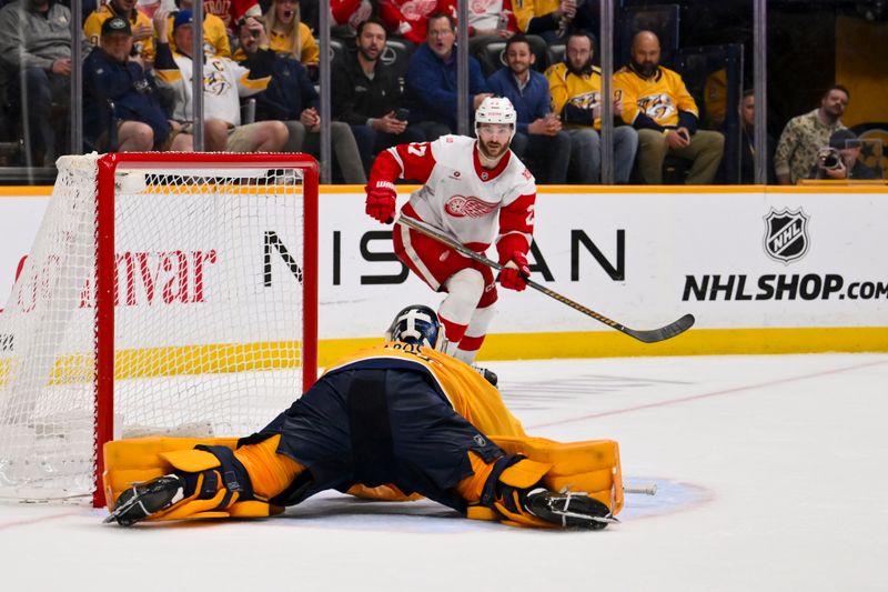 Mar 2, 2026; Nashville, Tennessee, USA;  Nashville Predators goaltender Juuse Saros (74) blocks the shot of Detroit Red Wings center Michael Rasmussen (27) during the third period at Bridgestone Arena. Mandatory Credit: Steve Roberts-Imagn Images