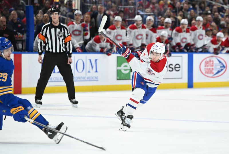 Nov 11, 2024; Buffalo, New York, USA; Montreal Canadiens defenseman Lane Hutson (48) shoots the puck in the third period against the Buffalo Sabres at KeyBank Center. Mandatory Credit: Mark Konezny-Imagn Images