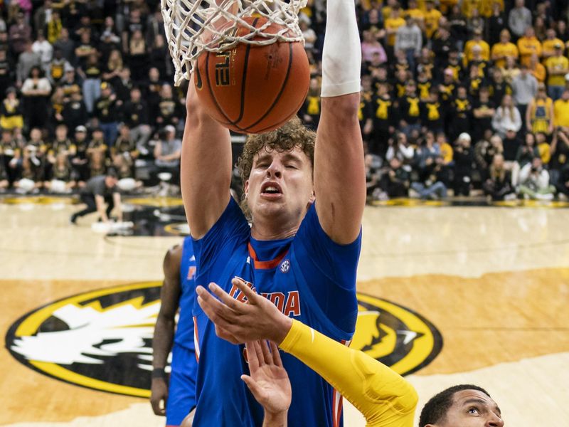 Jan 20, 2024; Columbia, Missouri, USA; Florida Gators center Micah Handlogten (3) dunks the ball against Missouri Tigers forward Noah Carter (35) during the first half at Mizzou Arena. Mandatory Credit: Jay Biggerstaff-USA TODAY Sports