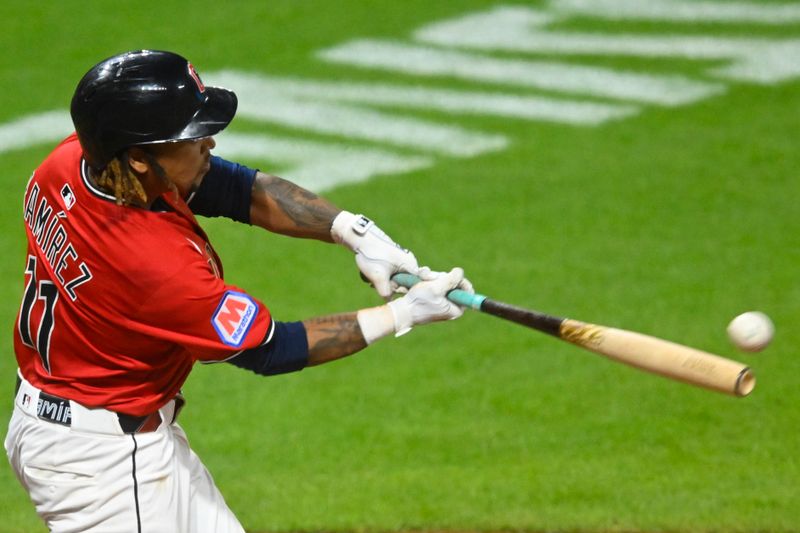 Jun 25, 2025; Cleveland, Ohio, USA; Cleveland Guardians third baseman Jose Ramirez (11) hits a game-winning RBI single in the tenth inning against the Toronto Blue Jays at Progressive Field. Mandatory Credit: David Richard-Imagn Images