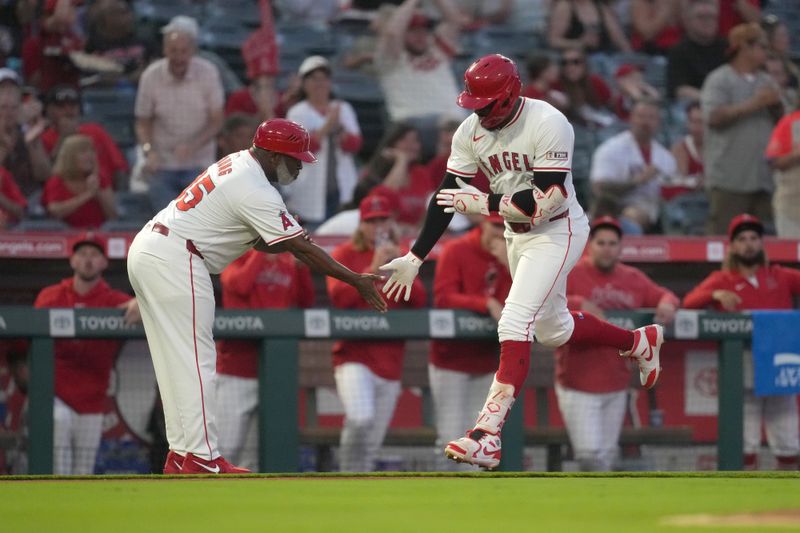 Aug 31, 2024; Anaheim, California, USA; Los Angeles Angels right fielder Jo Adell (7) is congratulated by third base coach Eric Young Sr. (85)  after hitting a home run in the third inning against the Seattle Mariners at Angel Stadium. Mandatory Credit: Kirby Lee-USA TODAY Sports