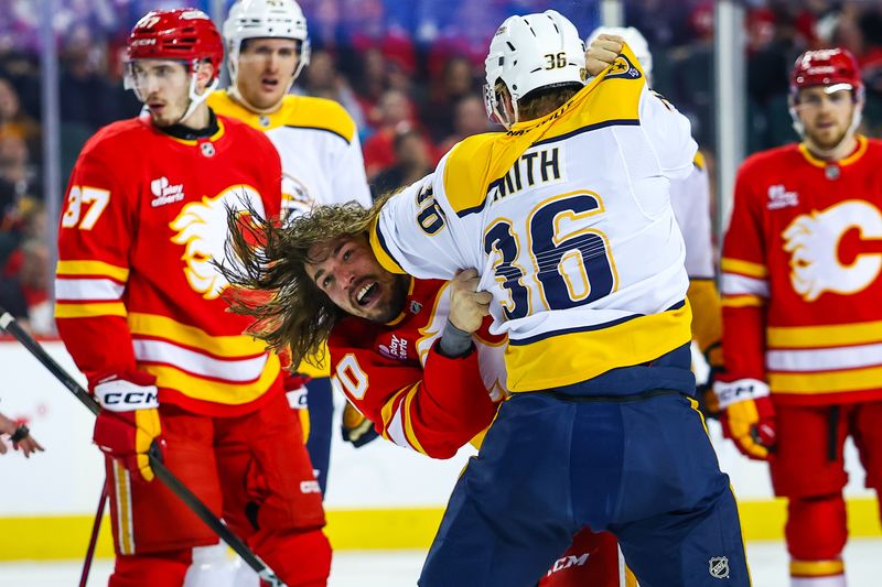 Jan 3, 2026; Calgary, Alberta, CAN; Calgary Flames left wing Ryan Lomberg (70) and Nashville Predators right wing Cole Smith (36) fight during the first period at Scotiabank Saddledome. Mandatory Credit: Sergei Belski-Imagn Images
