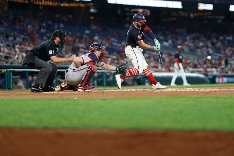 Sep 11, 2024; Washington, District of Columbia, USA; Washington Nationals first baseman Juan Yepez (18) singles against the Atlanta Braves during the third inning at Nationals Park. Mandatory Credit: Geoff Burke-Imagn Images