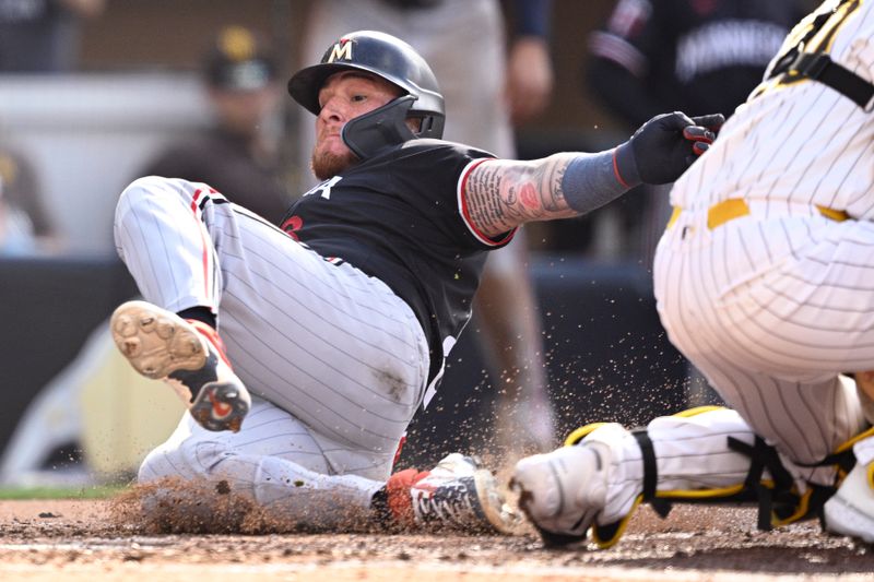 Aug 21, 2024; San Diego, California, USA; Minnesota Twins catcher Christian Vazquez (left) scores a run past San Diego Padres catcher Kyle Higashioka (20) during the fourth inning at Petco Park. Mandatory Credit: Orlando Ramirez-USA TODAY Sports