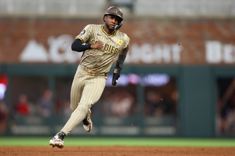 May 17, 2024; Atlanta, Georgia, USA; San Diego Padres left fielder Jurickson Profar (10) runs to third against the Atlanta Braves in the fifth inning at Truist Park. Mandatory Credit: Brett Davis-USA TODAY Sports