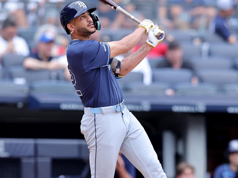 Jul 22, 2024; Bronx, New York, USA; Tampa Bay Rays center fielder Jose Siri (22) follows through on a solo home run during the fifth inning against the New York Yankees at Yankee Stadium. Mandatory Credit: Brad Penner-USA TODAY Sports