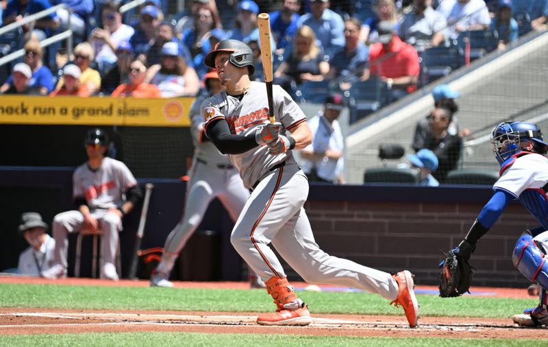 Jun 6, 2024; Toronto, Ontario, CAN;   Baltimore Orioles first baseman Ryan Mountcastle (6) hits a single against the Toronto Blue Jays in the first inning at Rogers Centre. Mandatory Credit: Dan Hamilton-USA TODAY Sports