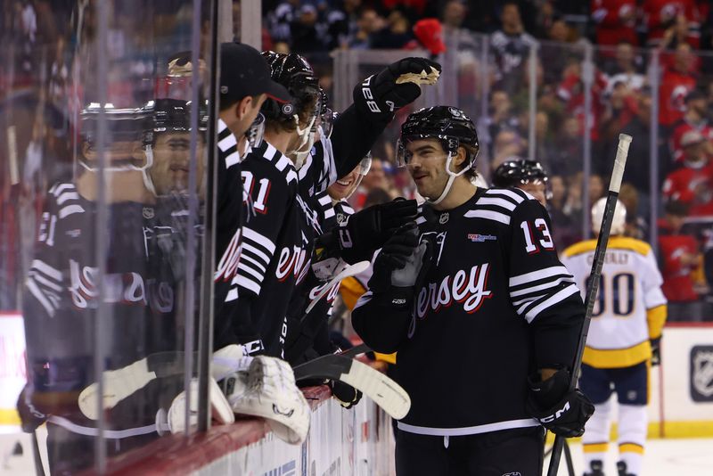 Nov 25, 2024; Newark, New Jersey, USA; New Jersey Devils center Nico Hischier (13) celebrates his goal against the Nashville Predators during the second period at Prudential Center. Mandatory Credit: Ed Mulholland-Imagn Images