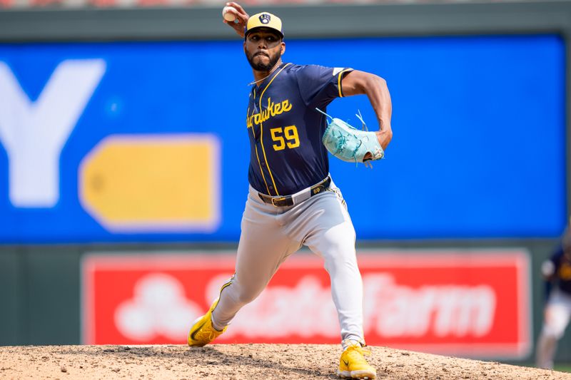 Jul 21, 2024; Minneapolis, Minnesota, USA; Milwaukee Brewers pitcher Elvis Peguero (59) pitches in the eighth inning against the Minnesota Twins at Target Field. Mandatory Credit: Matt Blewett-USA TODAY Sports