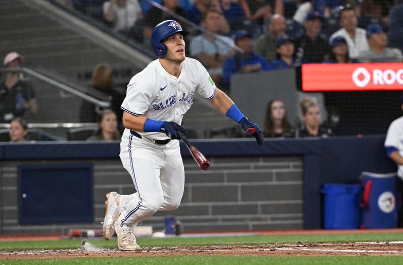 Aug 11, 2024; Toronto, Ontario, CAN; Toronto Blue Jays centre field Daulton Varsho (25) hits a solo home run in the fourth inning against the Oakland Athletics at Rogers Centre. Mandatory Credit: Gerry Angus-USA TODAY Sports