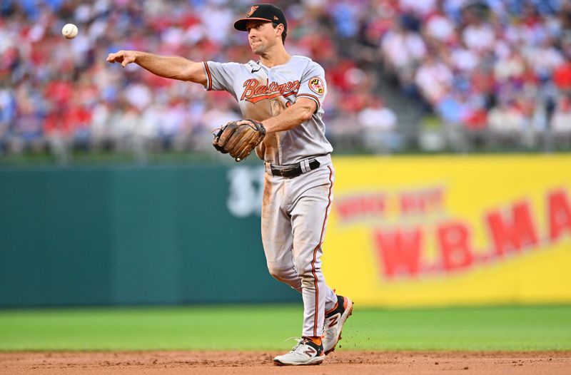 Jul 25, 2023; Philadelphia, Pennsylvania, USA; Baltimore Orioles second baseman Adam Frazier (12) throws to first against the Philadelphia Phillies in the third inning at Citizens Bank Park. Mandatory Credit: Kyle Ross-USA TODAY Sports
