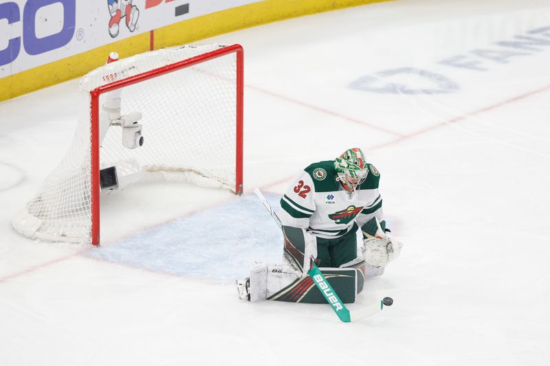 Feb 7, 2024; Chicago, Illinois, USA; Minnesota Wild goaltender Filip Gustavsson (32) defends a shot against the Chicago Blackhawks during the first period at United Center. Mandatory Credit: Kamil Krzaczynski-USA TODAY Sports