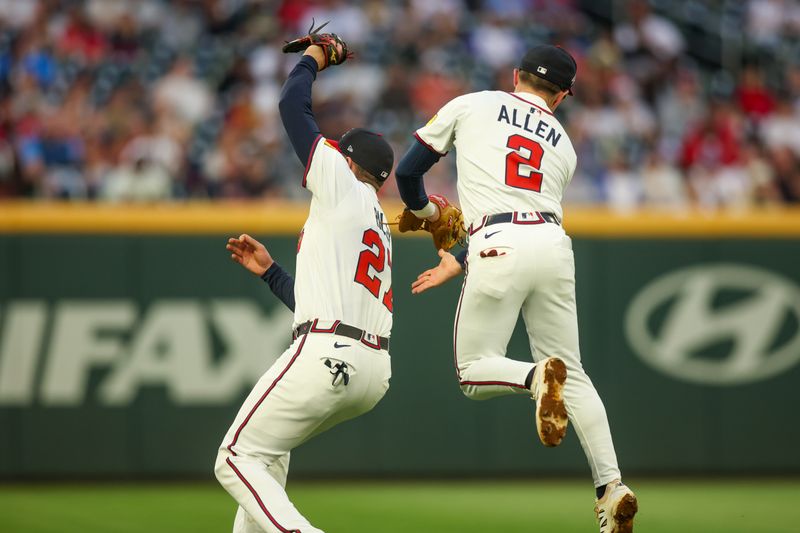 May 7, 2025; Atlanta, Georgia, USA; Atlanta Braves third baseman Austin Riley (27) catches a pop fly in front of shortstop Nick Allen (2) against the Cincinnati Reds in the fourth inning at Truist Park. Mandatory Credit: Brett Davis-Imagn Images
