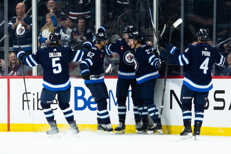 Feb 20, 2024; Winnipeg, Manitoba, CAN; Winnipeg Jets forward Mason Appleton (22) is congratulated by his team mates on his goal against the Minnesota Wild during the first period at Canada Life Centre. Mandatory Credit: Terrence Lee-USA TODAY Sports