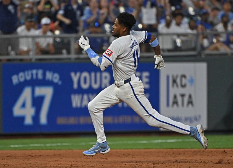 Jun 27, 2024; Kansas City, Missouri, USA;  Kansas City Royals second baseman Maikel Garcia (11) hits a RBI triple in the sixth inning against the Cleveland Guardians at Kauffman Stadium. Mandatory Credit: Peter Aiken-USA TODAY Sports