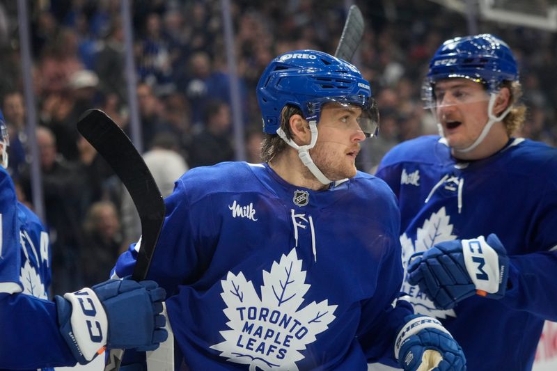 Nov 20, 2024; Toronto, Ontario, CAN; Toronto Maple Leafs forward Bobby McMann (74) congratulates forward William Nylander (88) on his goal against the Vegas Golden Knights during the third period at Scotiabank Arena. Mandatory Credit: John E. Sokolowski-Imagn Images