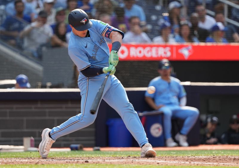 Sep 4, 2024; Toronto, Ontario, CAN; Toronto Blue Jays catcher Brian Serven (15) hits a double against the Philadelphia Phillies during the fifth inning at Rogers Centre. Mandatory Credit: Nick Turchiaro-Imagn Images