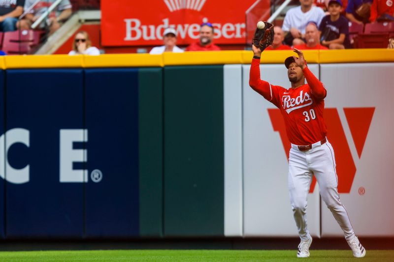 May 24, 2025; Cincinnati, Ohio, USA; Cincinnati Reds outfielder Will Benson (30) catches a fly out hit by Chicago Cubs outfielder Pete Crow-Armstrong (not pictured) in the eighth inning at Great American Ball Park. Mandatory Credit: Katie Stratman-Imagn Images