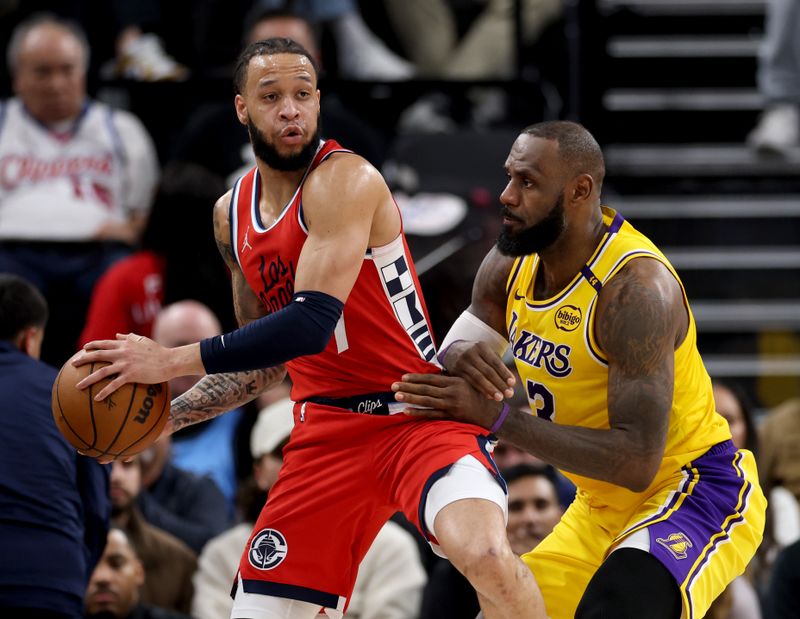 INGLEWOOD, CALIFORNIA - FEBRUARY 04: Amir Coffey #7 of the LA Clippers is guarded by LeBron James #23 of the Los Angeles Lakers during a 122-97 Lakers win at Intuit Dome on February 04, 2025 in Inglewood, California. (Photo by Harry How/Getty Images) User expressly acknowledges and agrees that, by downloading and or using this photograph, User is consenting to the terms and conditions of the Getty Images License Agreement. (Photo by Harry How/Getty Images)